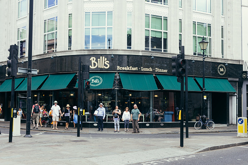 London, UK - July 23, 2018: Bill's Greenwich Restaurant is positioned on the corner of the bustling Nelson Road and Greenwich Church Street