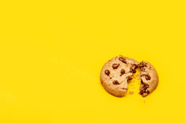 istock Chocolate chip cookie isolated on yellow background 1138671957