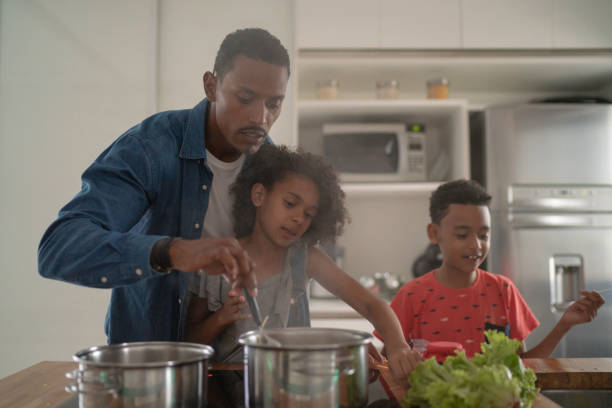 istock Family Cooking Together at Kitchen 1138672023