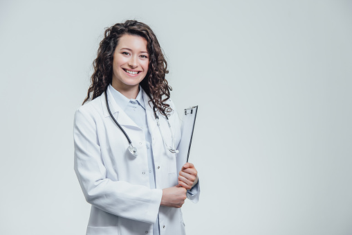 Portrait of female doctor on white background,