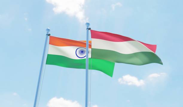 istock Hungary and India, two flags waving against blue sky 1138675020