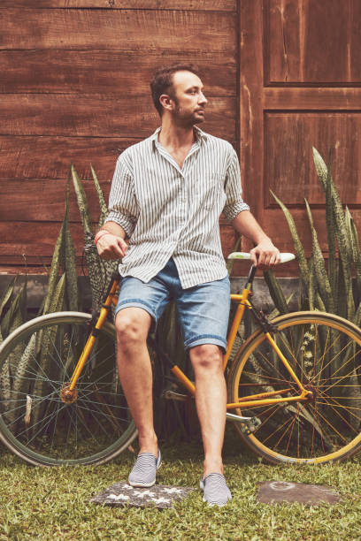 istock Attractive man standing with old bicycle. 1138675495
