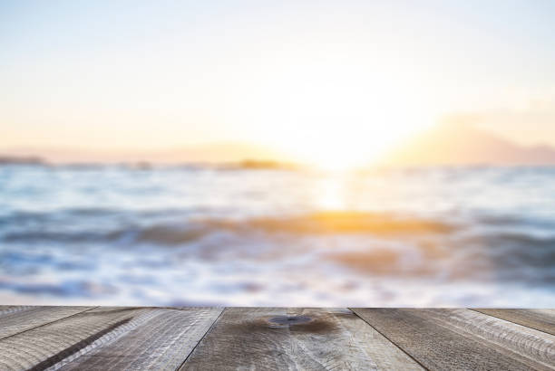 istock Empty wooden table and beautiful ocean at sunset. Summer background. 1138676304