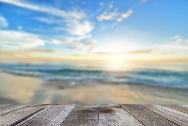 istock Empty wooden table with sea, sand beach and beautiful sunrise. 1138676305
