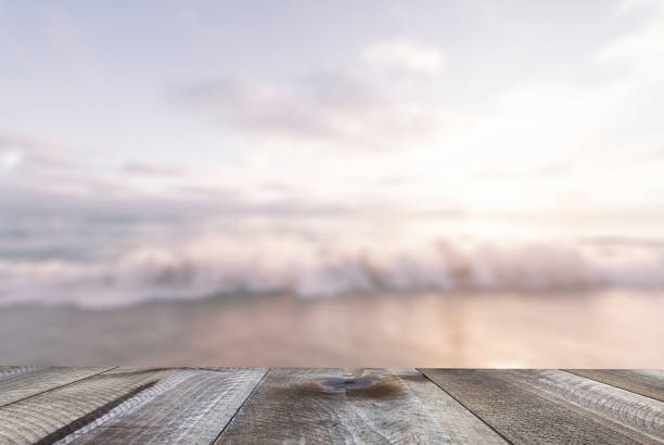 istock Woodeen table with sand beach and sea. Pastel sunset background. 1138676309
