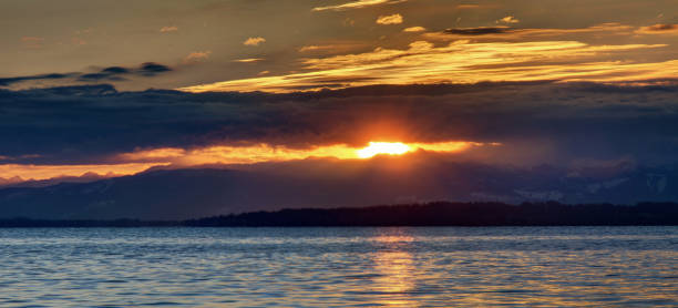 istock cloudy sunrise with at sea bay 1138676948