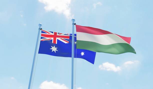 istock Hungary and Australia, two flags waving against blue sky 1138677880