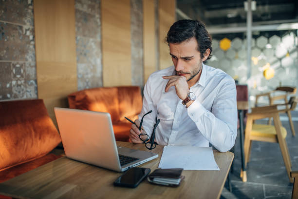 istock Businessman working on laptop in cafe 1138677896