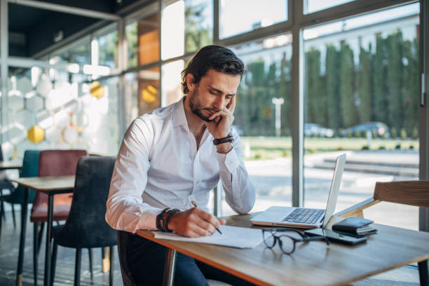 istock Businessman working on laptop in cafe 1138678572