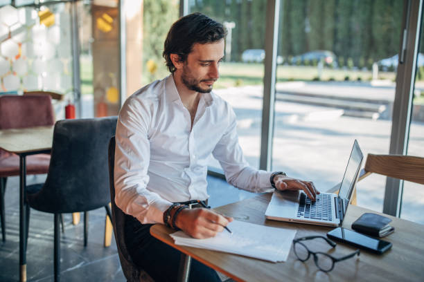 istock Businessman working on laptop in cafe 1138679258