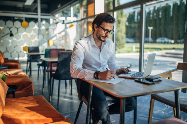 istock Businessman working on laptop in cafe 1138679310