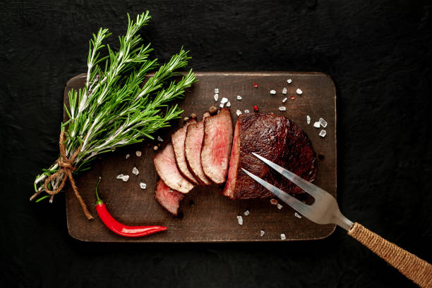 istock beef steak on a cutting board. on a dark concrete background 1138682958
