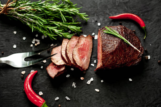 istock beef steak on a cutting board. on a dark concrete background 1138683159