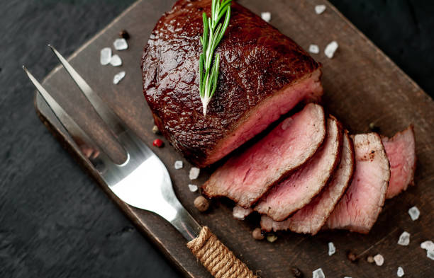 istock beef steak on a cutting board. on a dark concrete background 1138683163