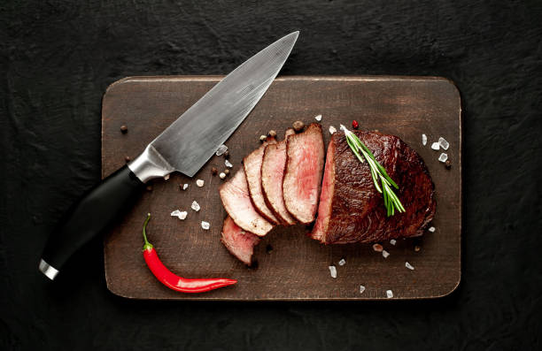 istock beef steak on a cutting board. on a dark concrete background 1138683200