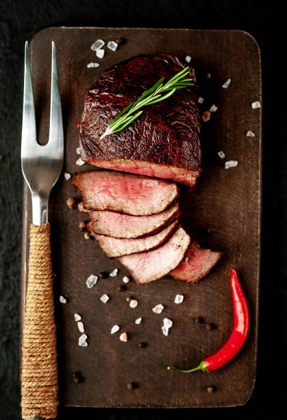istock beef steak on a cutting board. on a dark concrete background 1138683250