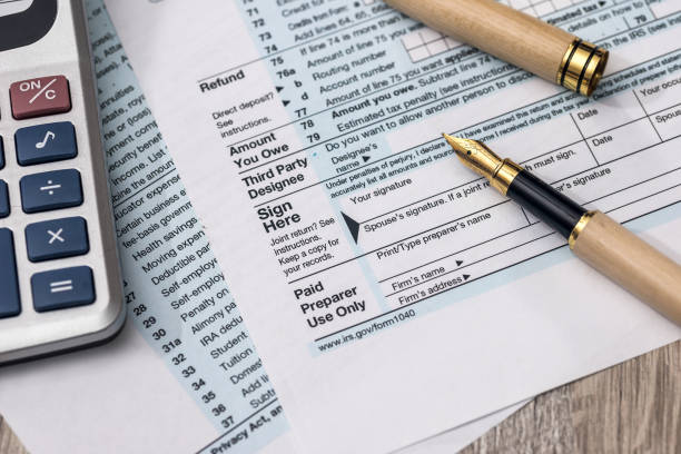 istock 1040 tax form with calculator and pen 1138686108