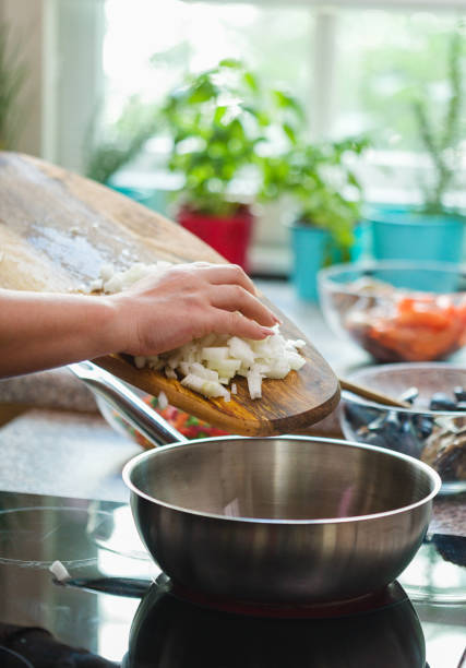 istock Young Woman Preparing Paella 1138688446