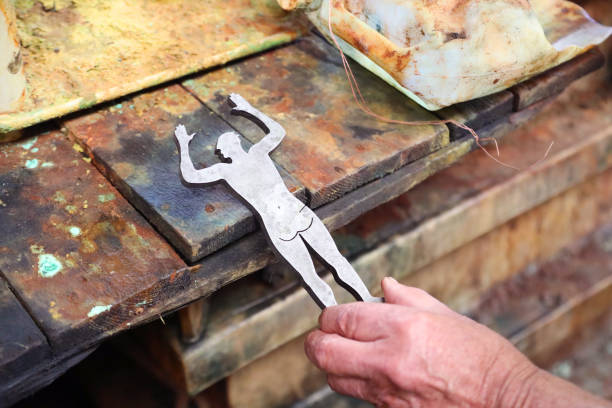 A Senior artist electroplating his artwork.