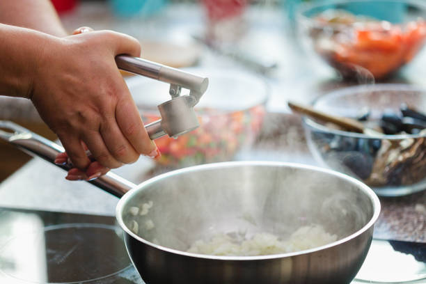 istock Young Woman Preparing Paella 1138688787