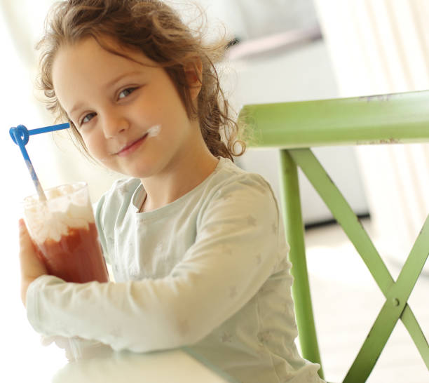 istock Cute little girl drinking cocktail 1138689535