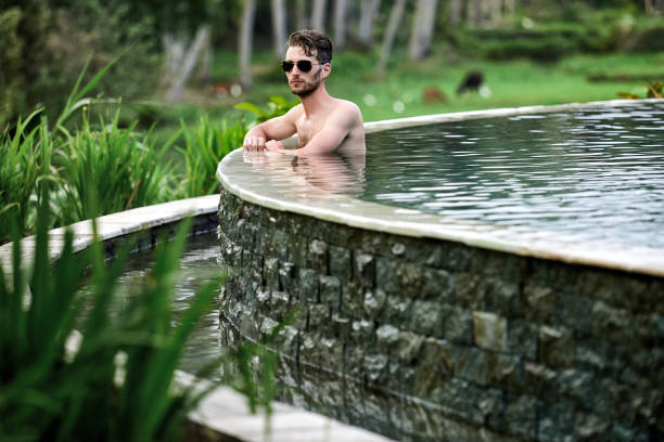 istock Young man at swimming pool. 1138691559