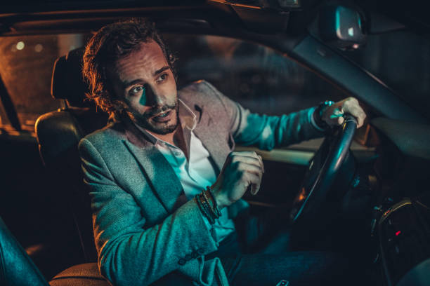 istock Businessman Driving A Car In Night 1138692641