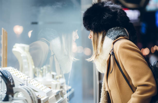 istock Beautiful girl window shopping 1138692677