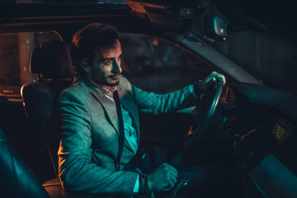 istock Businessman Driving A Car In Night 1138692722