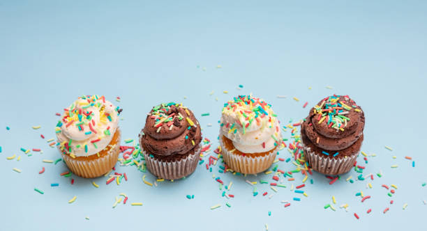istock Cupcakes with colorful sprinkles on blue pastel background, copy space. 1138692748