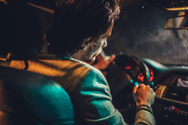 istock Man Driving A Car In Night 1138692891