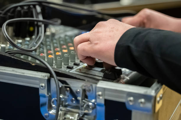 istock Studio Sound Mixing board with hands on buttons and selective focus 1138692925