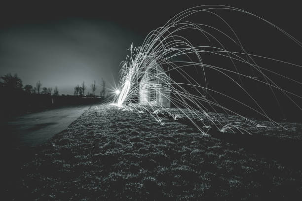 istock Rotating steel wool with sparkling burning sparks in the night with long exposure shutter photographed in different variations 1138692953