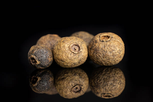 istock Dry allspice berries isolated on black glass 1138693099