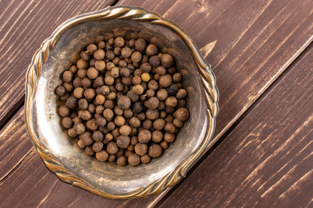 istock Dry allspice berries on brown wood 1138693124