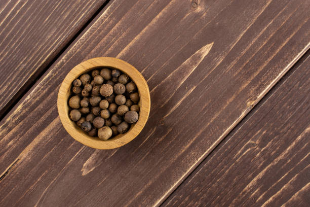 istock Dry allspice berries on brown wood 1138693141