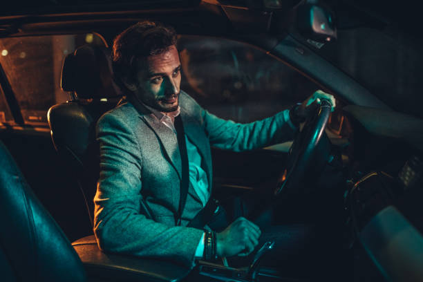 istock Man Driving A Car In Night 1138693958