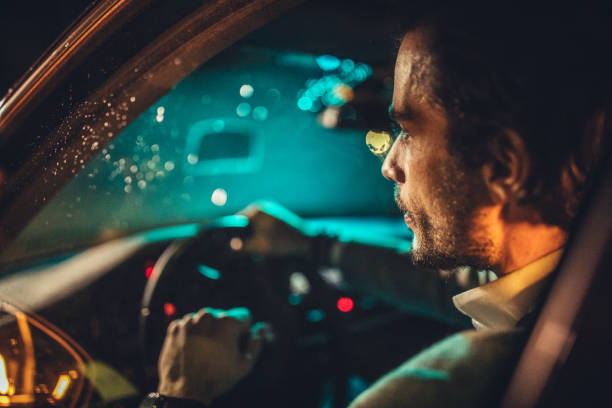 istock Man Driving A Car In Night 1138694052