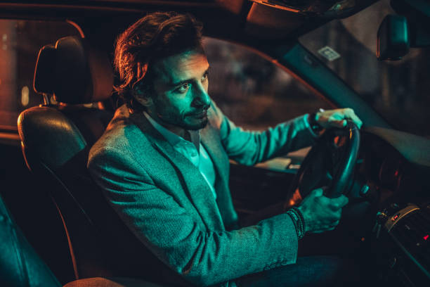 istock Businessman Driving A Car In Night 1138695314