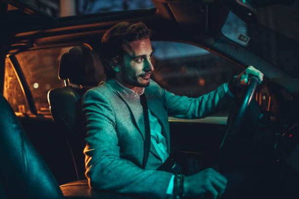 istock Man Driving A Car In Night 1138695633