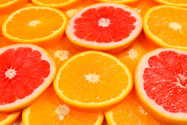 istock Slices of oranges and a grapefruits as a background. 1138696330