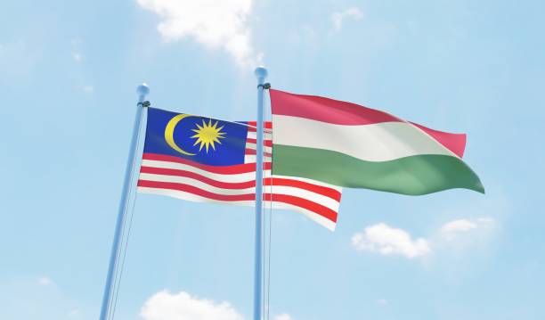 istock Hungary and Malaysia, two flags waving against blue sky 1138698581