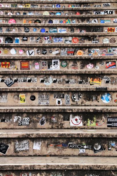 Lisbon, Portugal- March 18, 2019: Marble steps filled with colorful advertising stickers in a street of Lisbon, Portugal.