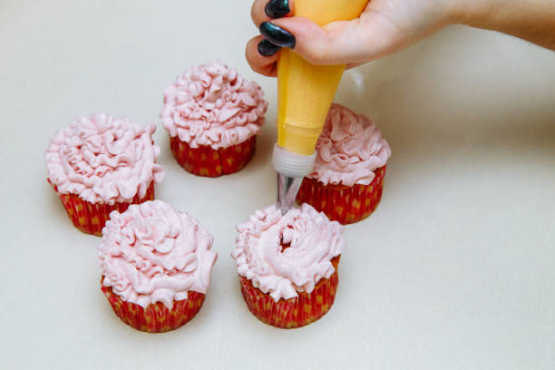istock Cooking cupcakes at home. Pink Cream Baking Decoration 1138699361
