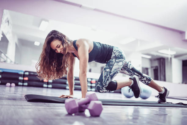 istock Cute Smiling Female Doing Cardiovascular Exercises In Gym 1138700423