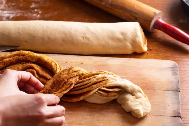 Photo of Food bakery concept making bread dought for Cinnamon Roll Braided Bread with copy space