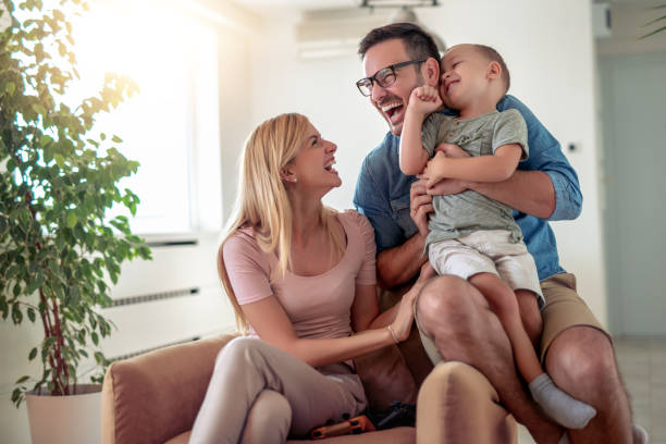 istock Cheerful parents playing with their little son at home 1138704764