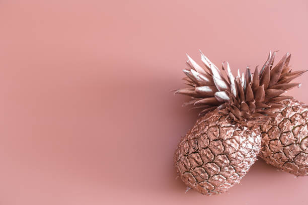 istock Gold colored pineapple on a colored background. Tropical flat lay. Food concept. 1138705791