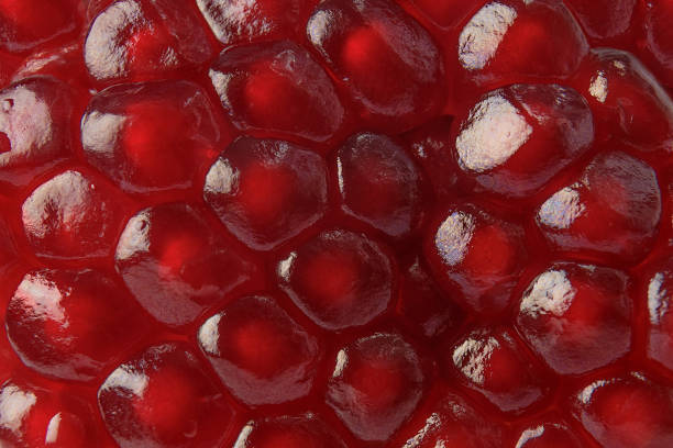 istock Red ripe juicy pomegranate seed background texture 1138707426
