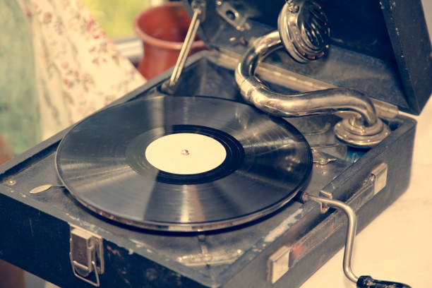 istock Old shabby gramophone, with a vinyl record.Toned. 1138709093